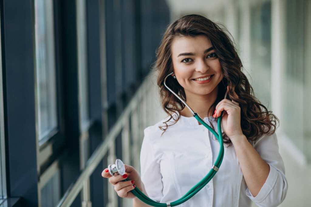 Female doctor at ABRO Clinics showcasing affordable health insurance and medical packages